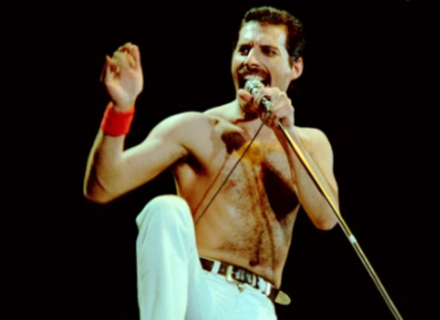 Freddie Mercury singing into a microphone